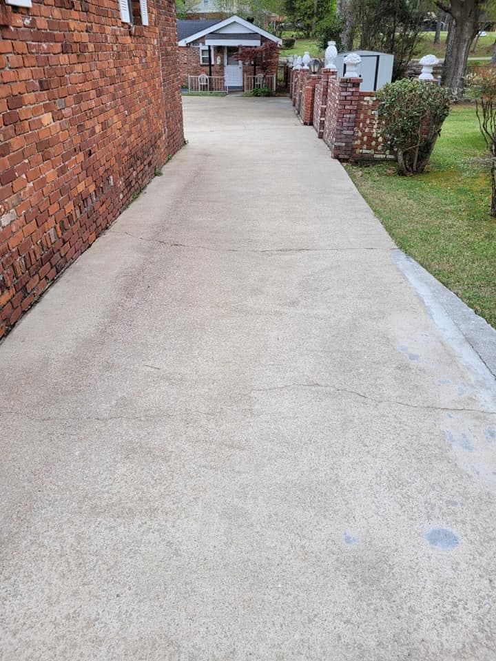 Cleaned concrete sidewalk along brick home